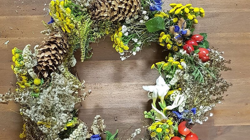 selbst hergestellter Frühlingskranz mit bunten Blumen