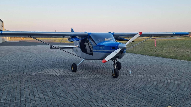 Ein kleines blaues Flugzeug auf einem Flugplatz