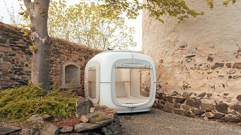 Der Cube steht auf der Burg an der Seite, auf der anderen Seite ein Baum und die Burgmauer